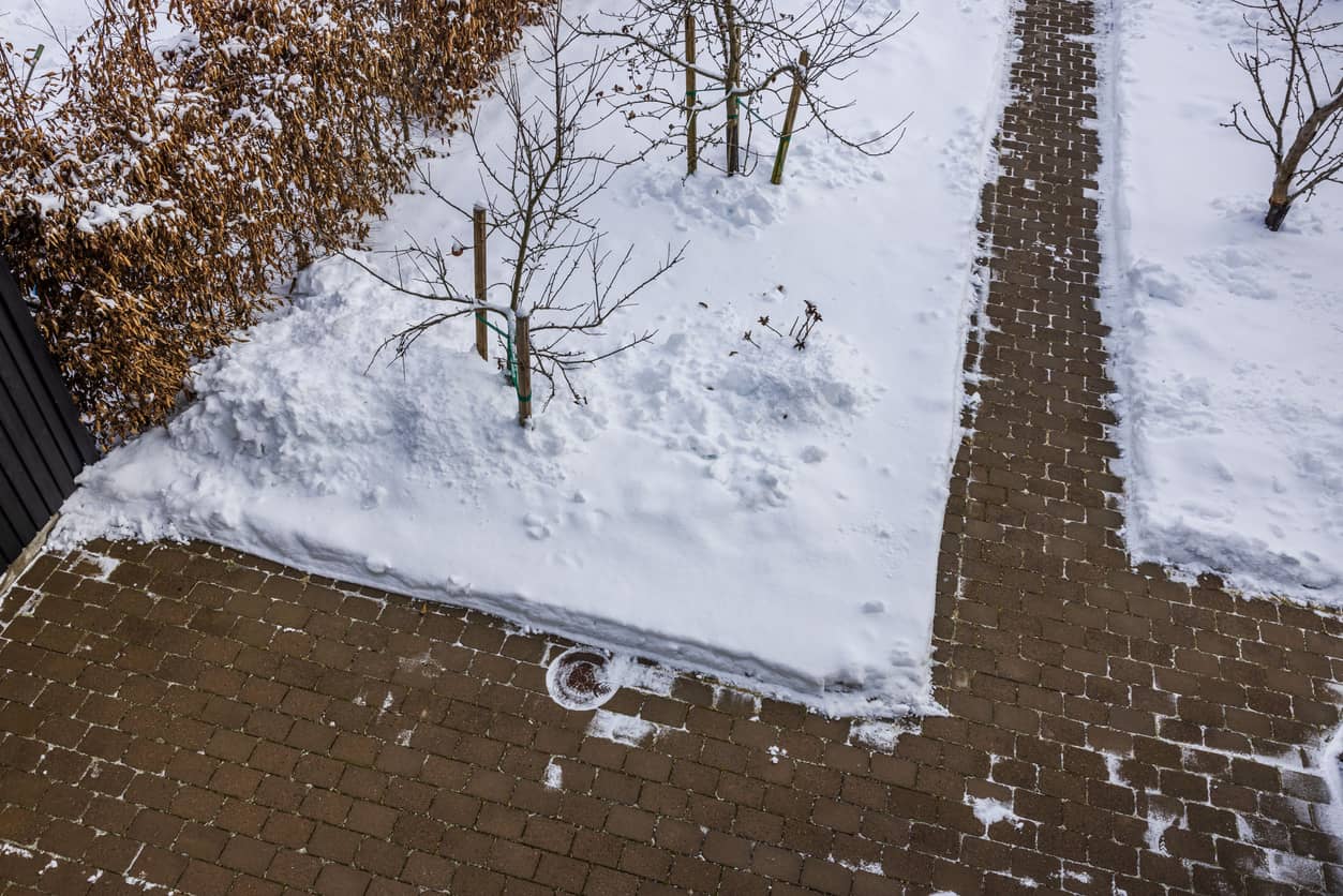 View of shoveled driveway and sidewalk from snow